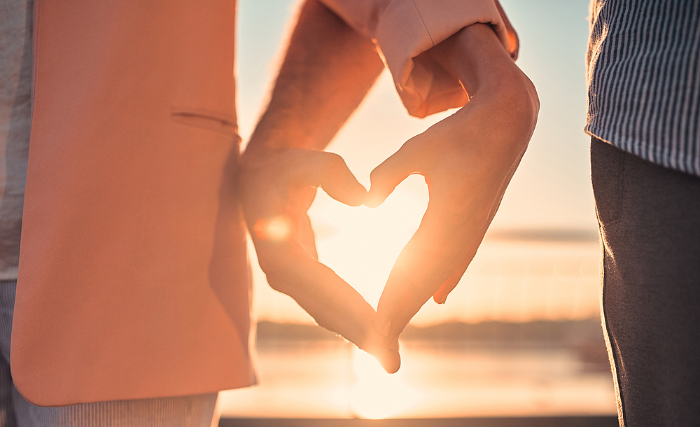 Love is in the air! Cute romantic couple spending time together in the city. Handsome bearded man and attractive young woman are in love. Hugging, kissing and having fun during the sunset.